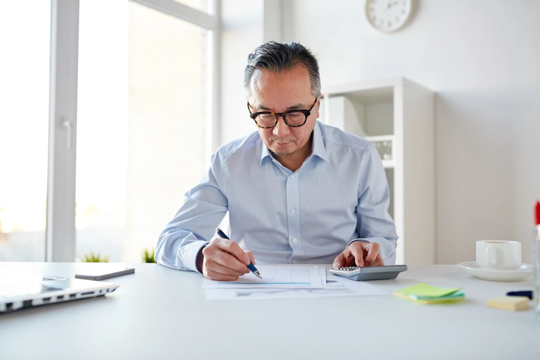 middle-aged-canadian-calculating-rrsp-contributions-using-investment-planning-worksheets-and-retirement-guides