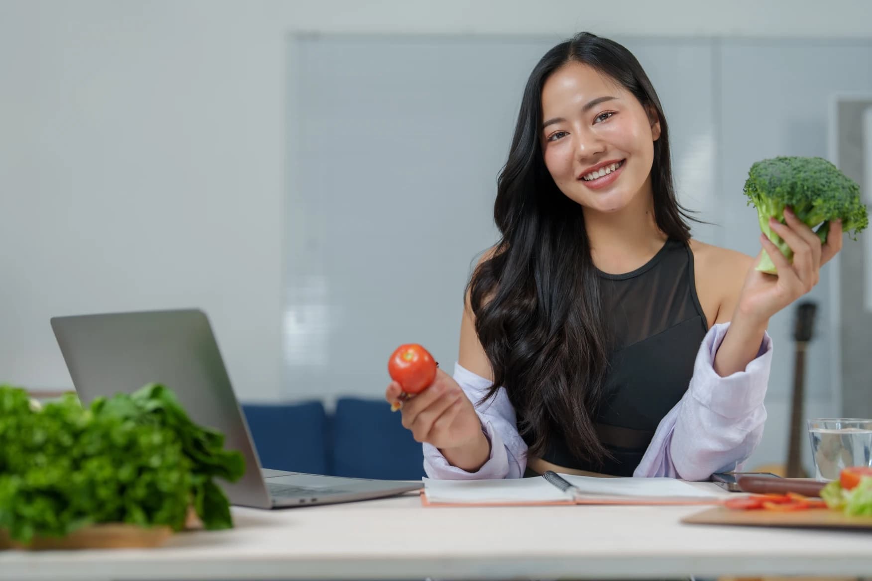 woman-with-laptop-making-ai-chat-meal-plan-next-to-groceries