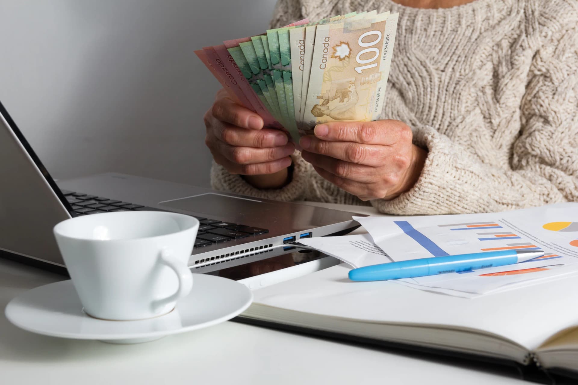 Woman counting bills on table Woman counting bills on table