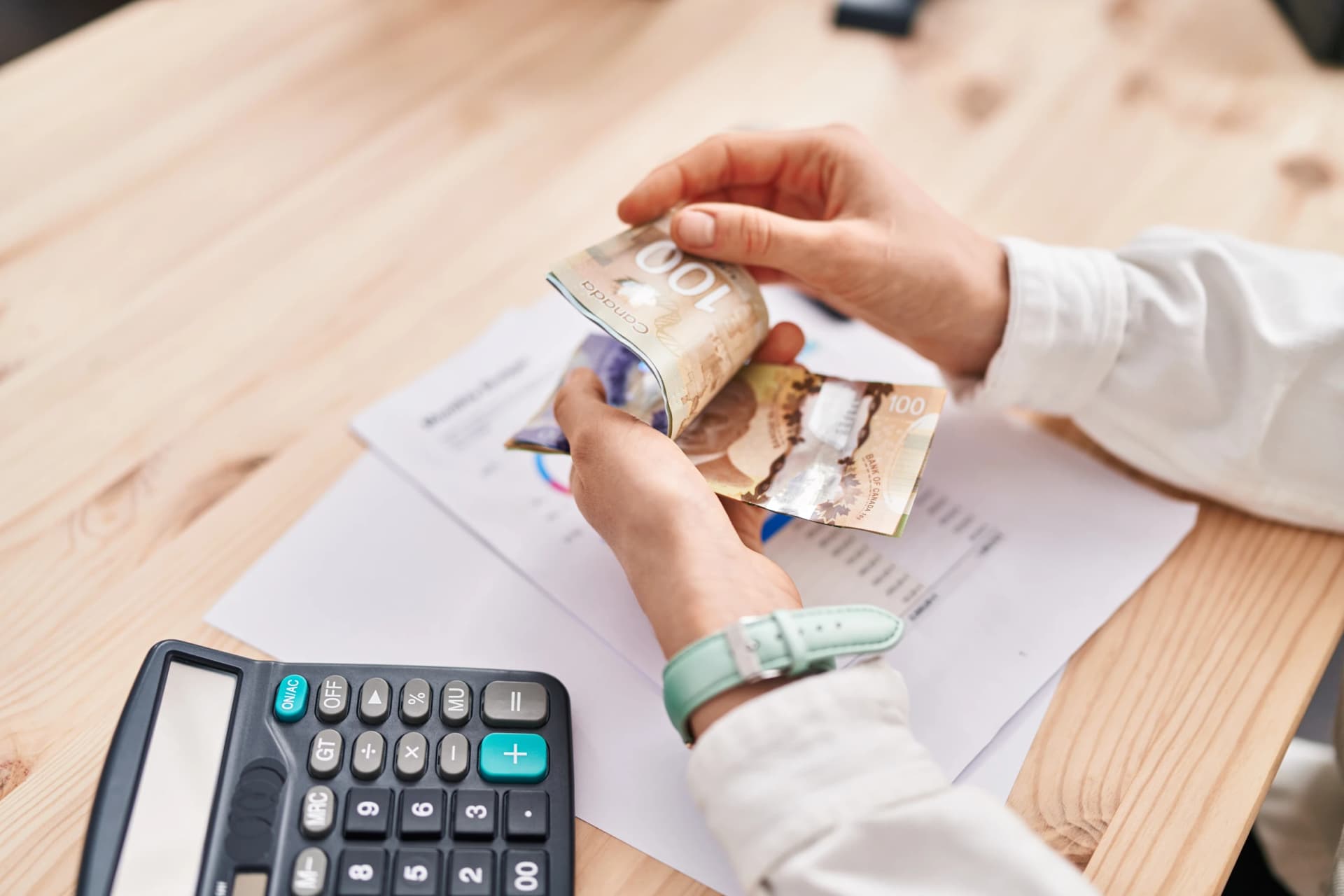 Woman counting canada dollars Woman counting canada dollars