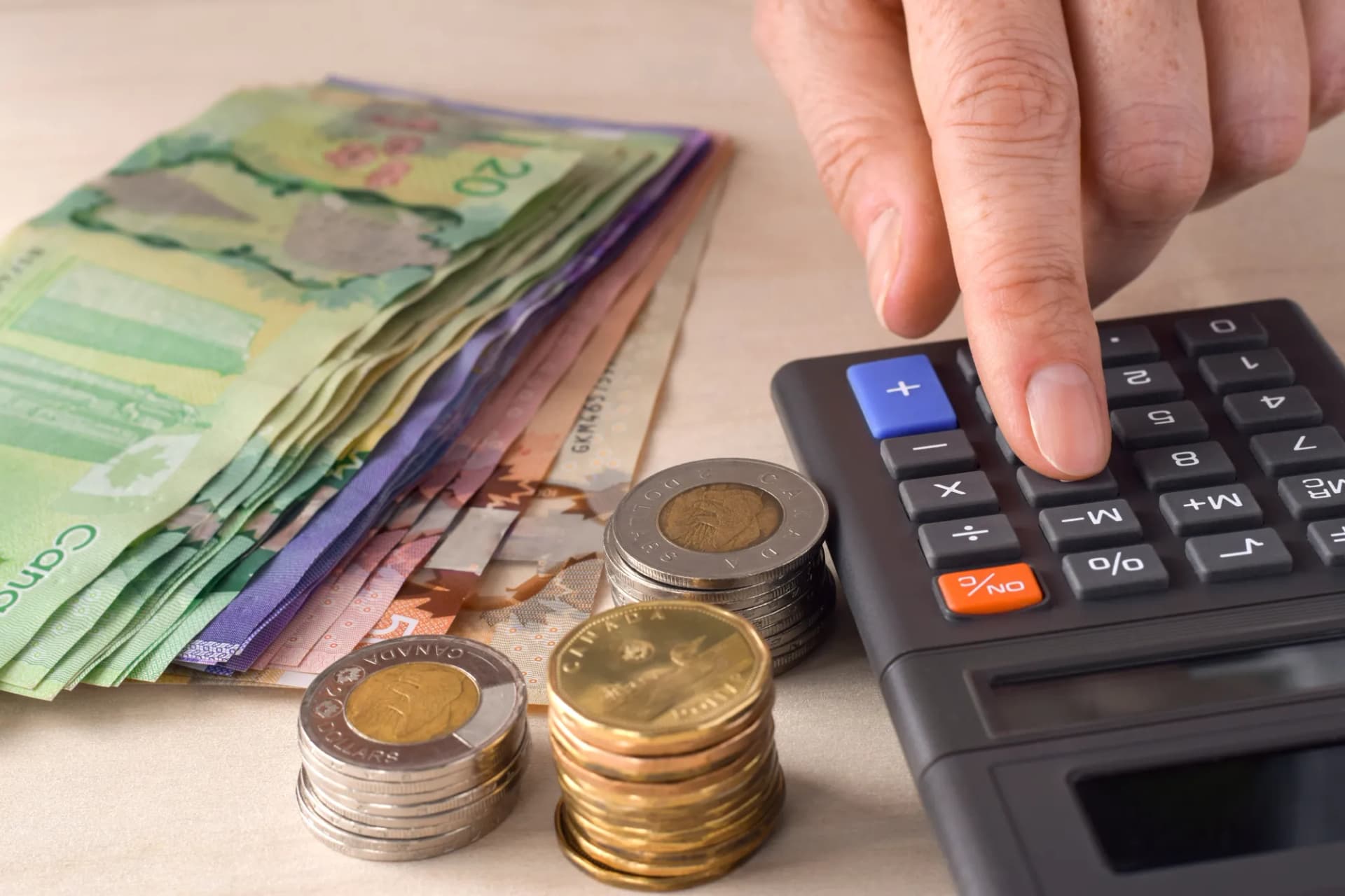 person using calculator counting money person using calculator counting money