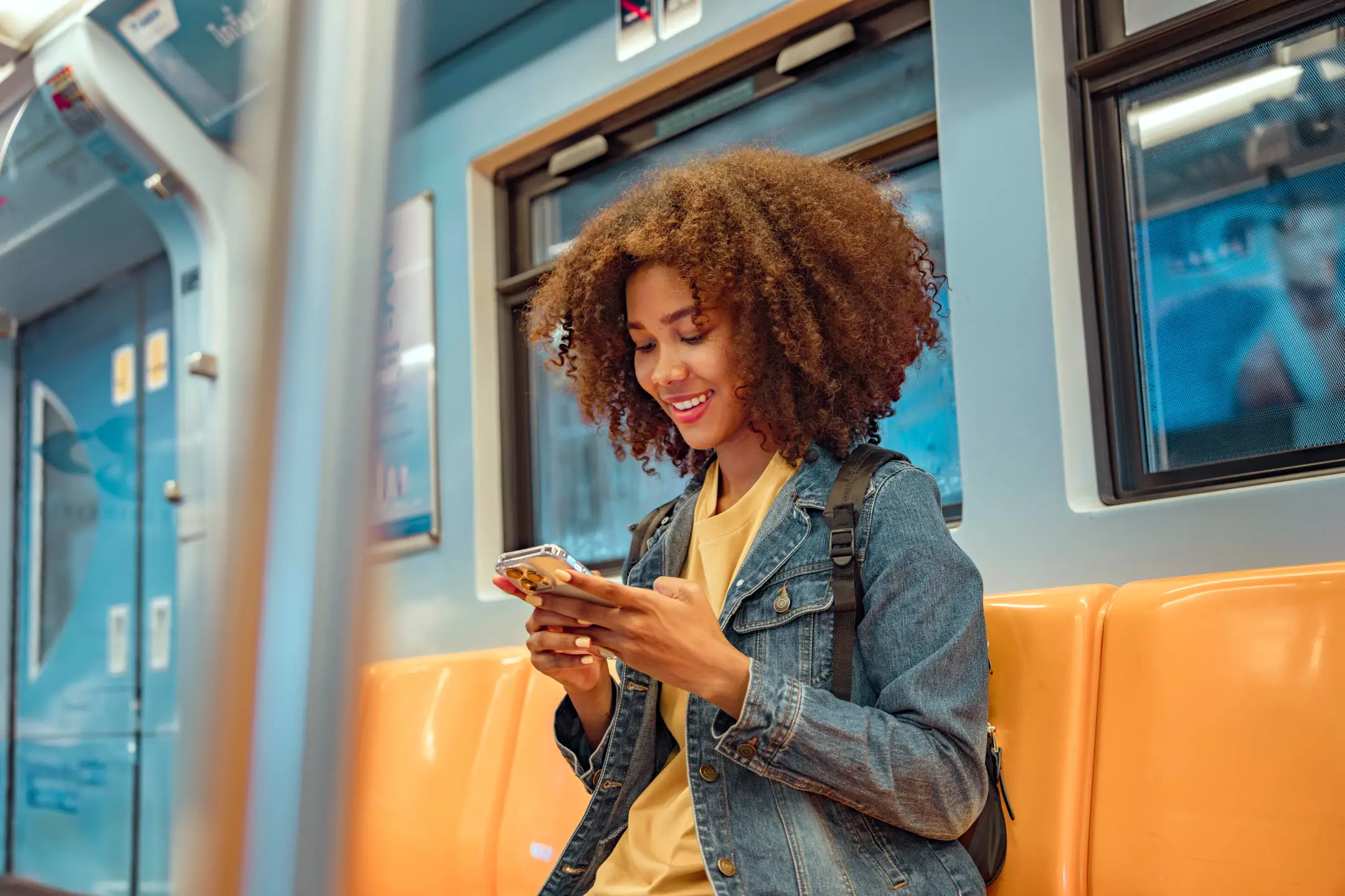 Happy young African American woman passenger smile and using smart mobile phone