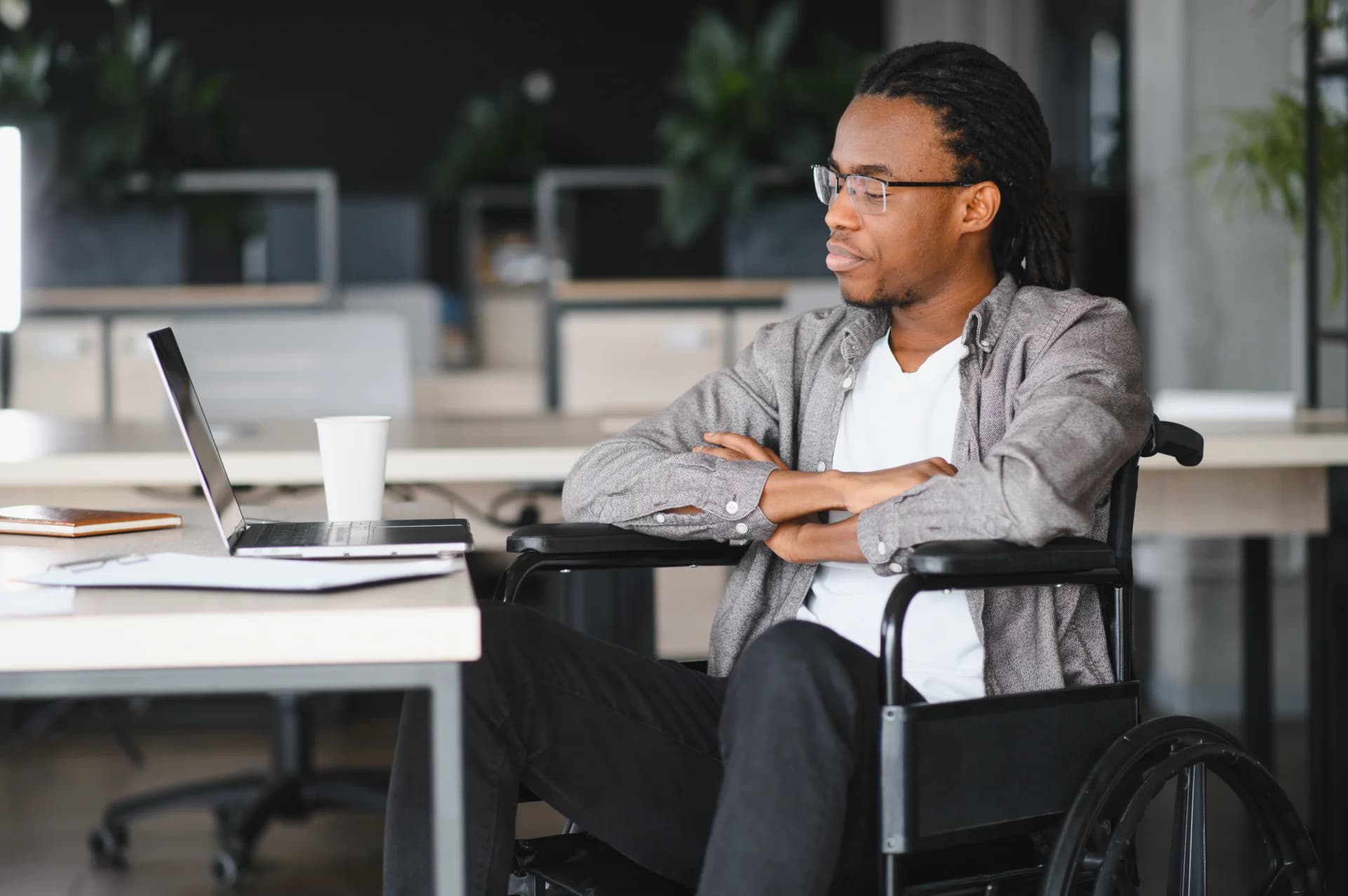 a-person-looking-over-disability-assistance-paperwork-with-a-concerned-expression