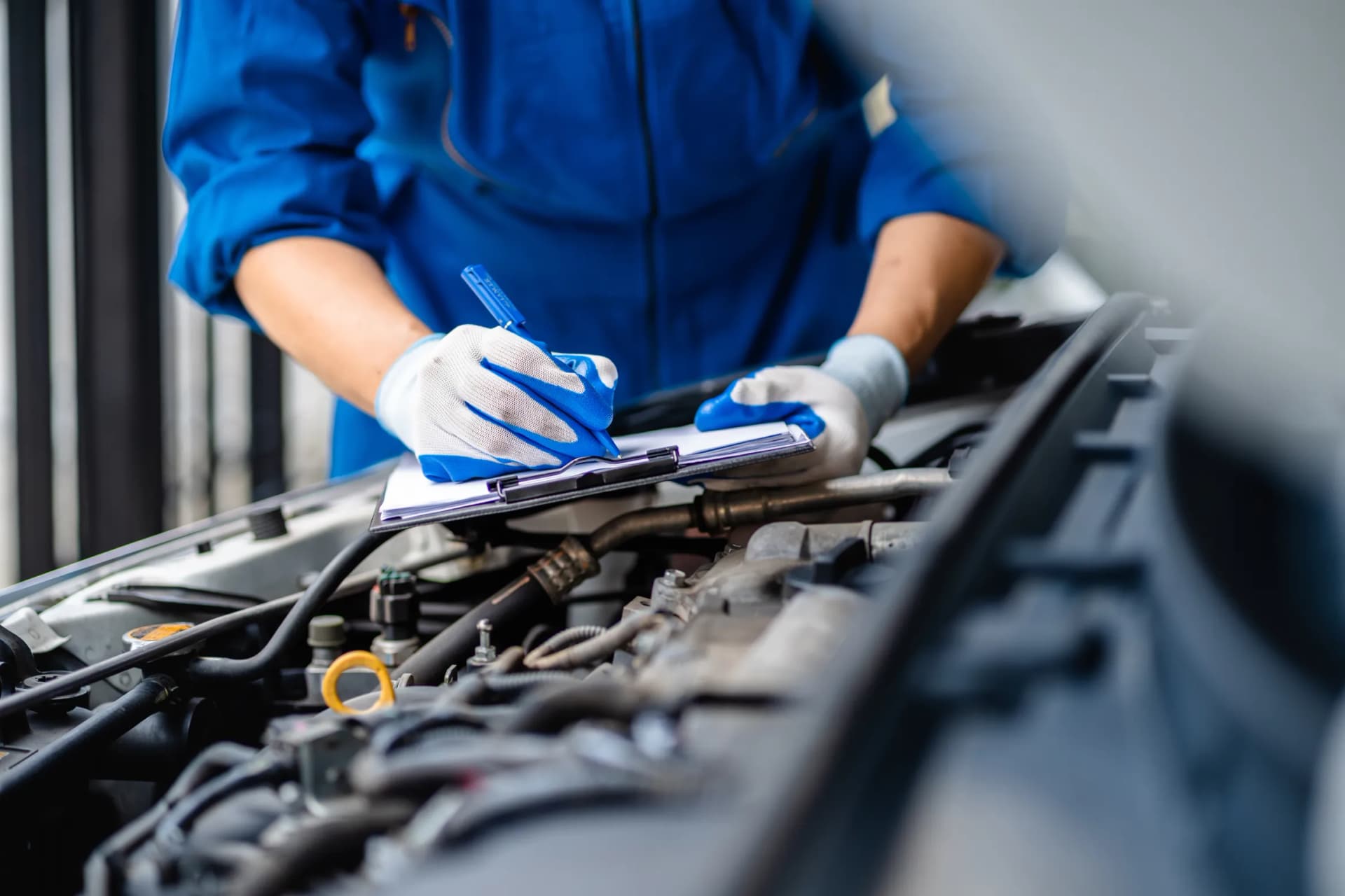 Automotive mechanic repairmen checking the car engine Automotive mechanic repairmen checking the car engine