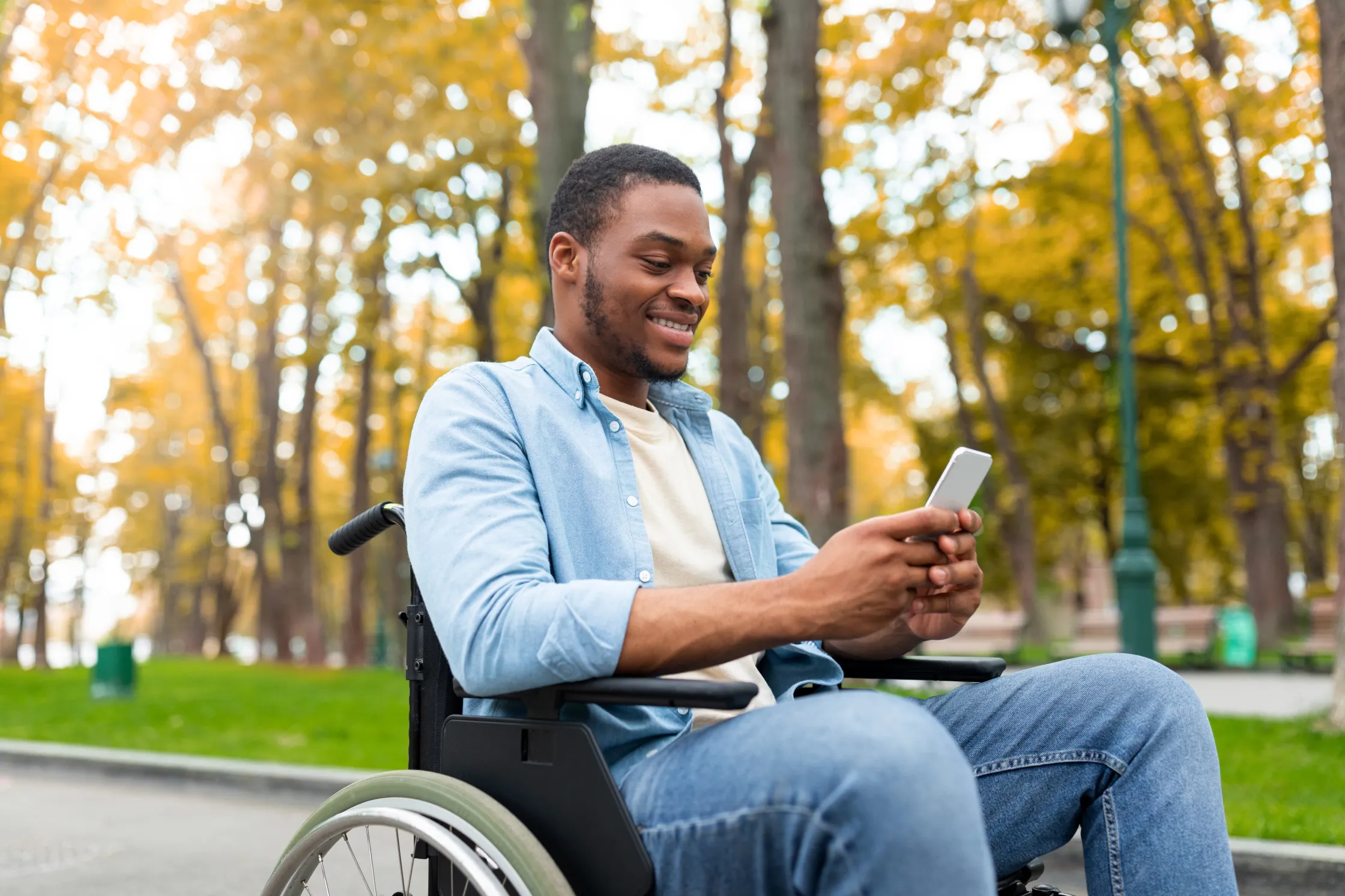 disabled-black-guy-in-wheelchair-using-mobile-phone
